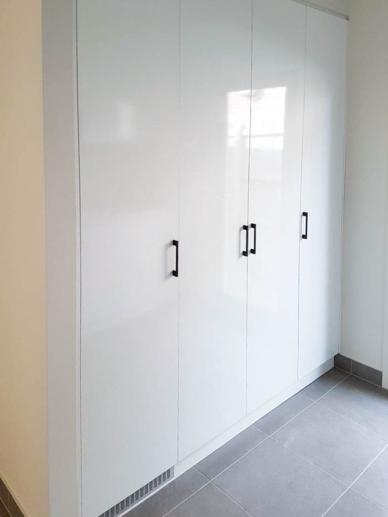 Laundry fitout with tall storage and pull-out hamper