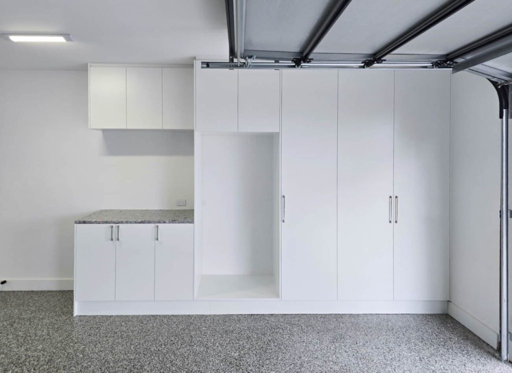 Custom laundry cabinetry with benchtop and overhead cupboards