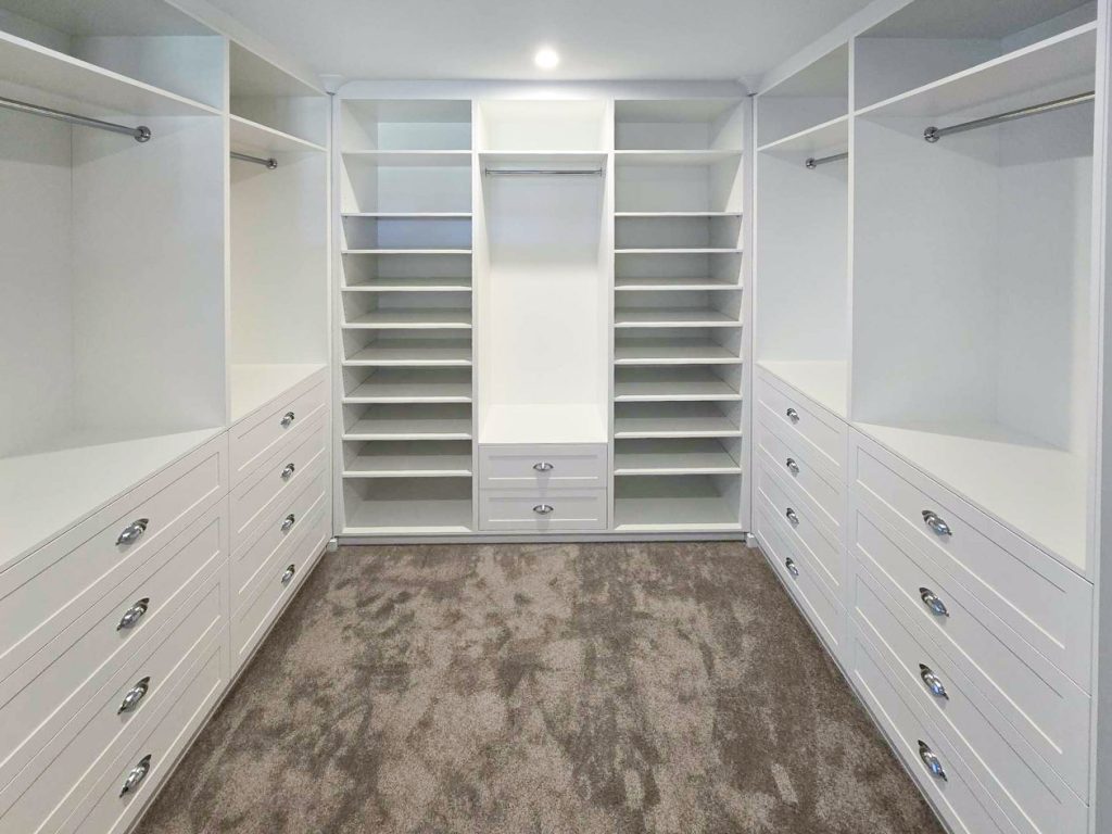 Custom dressing room with full-height hanging and shoe storage