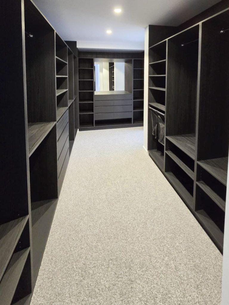 Custom walk-in robe interior with accessory storage